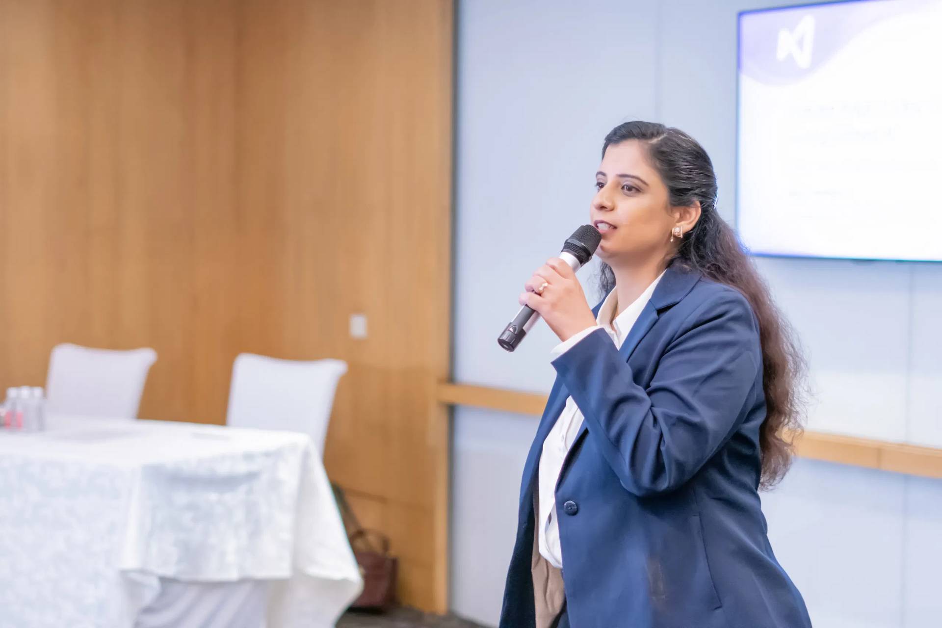 Sneh A. Malhotra speaking on stage